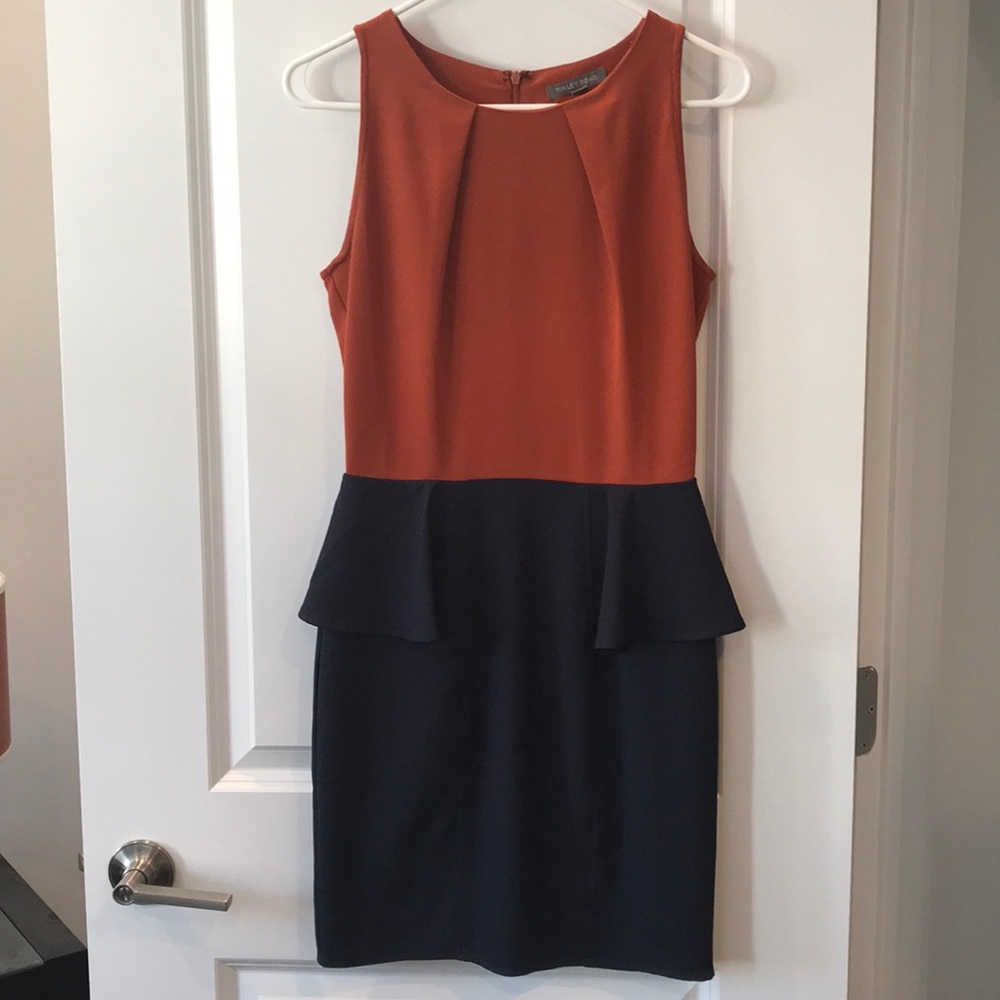 Rust orange and navy color blocked peplum dress